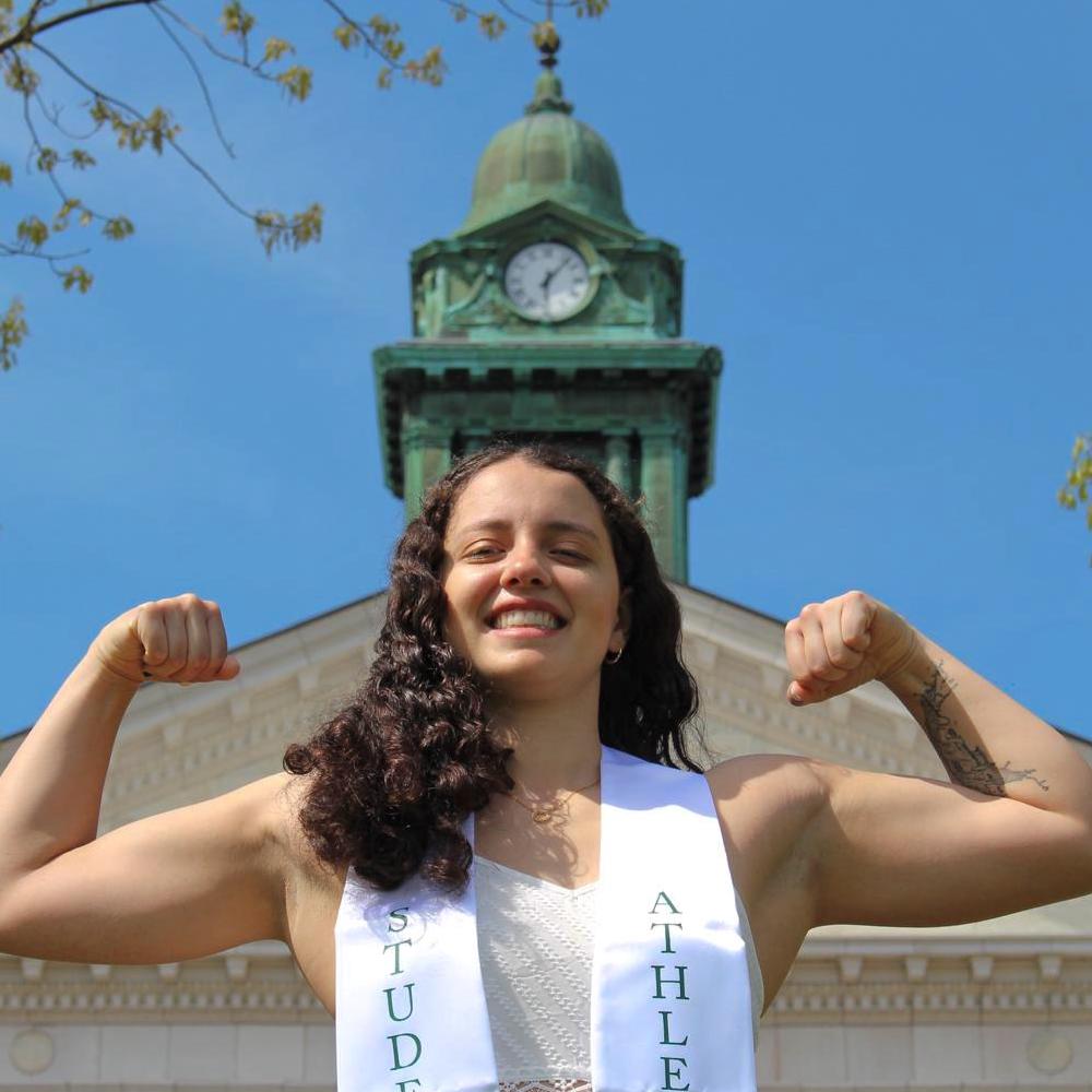 coach alexia flexing to camera