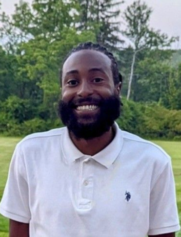 A person with a beard smilingAI-generated content may be incorrect.