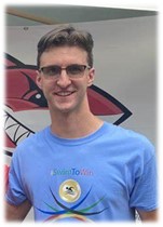 Two men holding a plaqueDescription automatically generated