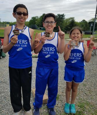 Flyers siblings Paul, Justin, and Elizabeth Koizumi display their new gold medals