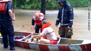 In the canoe, Neelyann Sheucraft lifts a duffel bag holding her family dogs.
