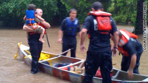 Neelyann Sheucraft and daughter Lowell Ann were rescued from floodwaters that burst into their home.